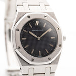 Closeup photo of a Vintage Audemars Piguet Royal Oak 6008ST from 1980s on a wrist. Stainless Steel, 30mm with original black tapisserie dial and Quartz movement.