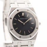 Closeup photo of a Vintage Audemars Piguet Royal Oak 6008ST from 1980s on a wrist. Stainless Steel, 30mm with original black tapisserie dial and Quartz movement.