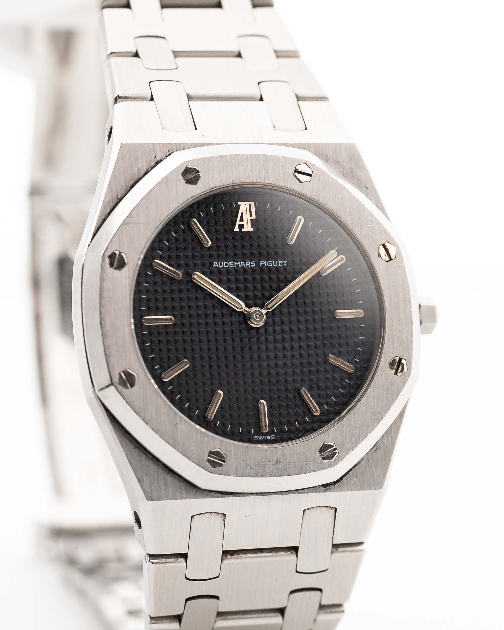 Closeup photo of a Vintage Audemars Piguet Royal Oak 6008ST from 1980s on a wrist. Stainless Steel, 30mm with original black tapisserie dial and Quartz movement.