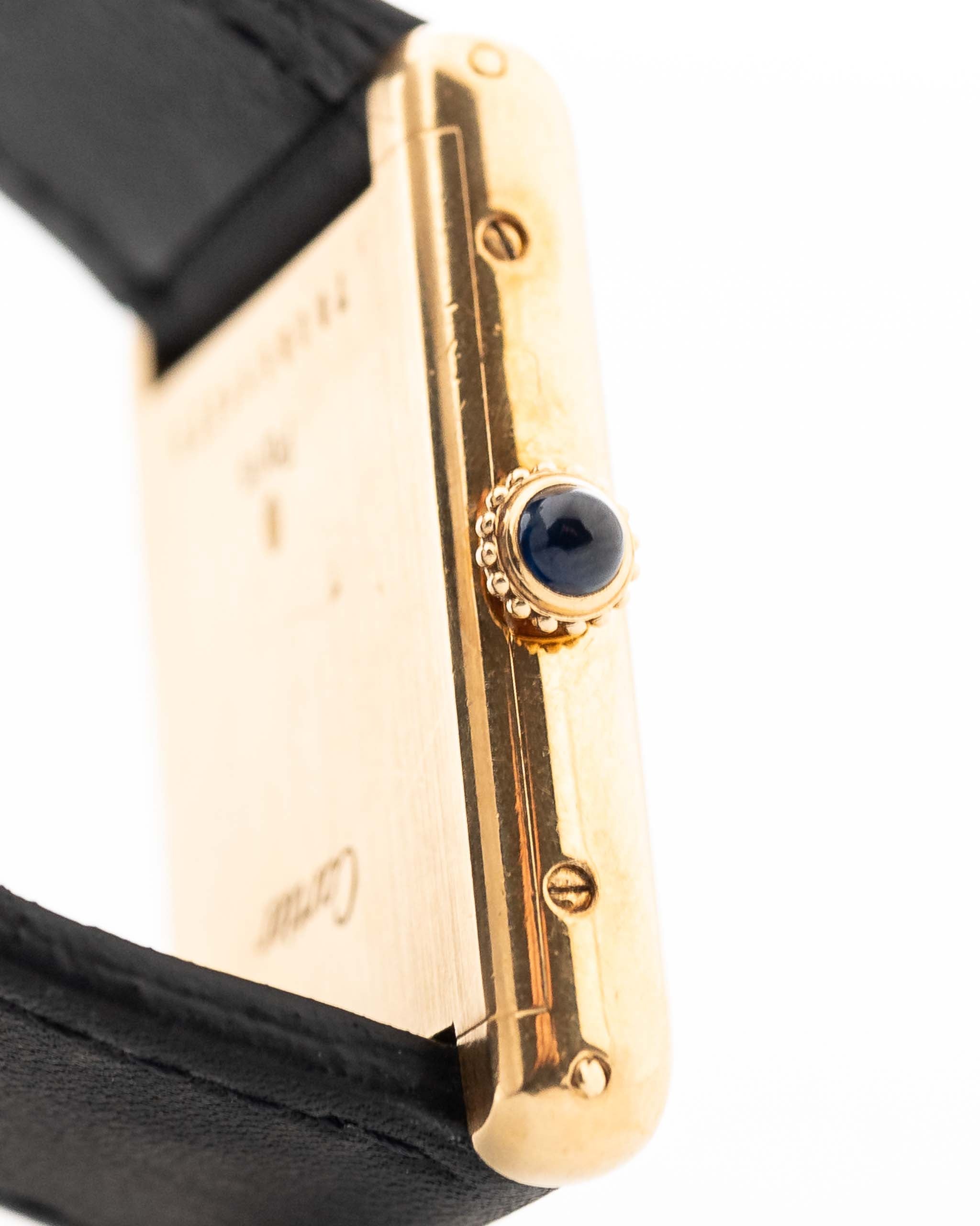 Closeup of a Vintage Cartier Tank Louis 78086 Paris Case from the 1970s. 23x30mm with 18k Yellow Gold Case, Manual Wind Movement, Flawless Ivory Dial, Hands and Leather Strap.