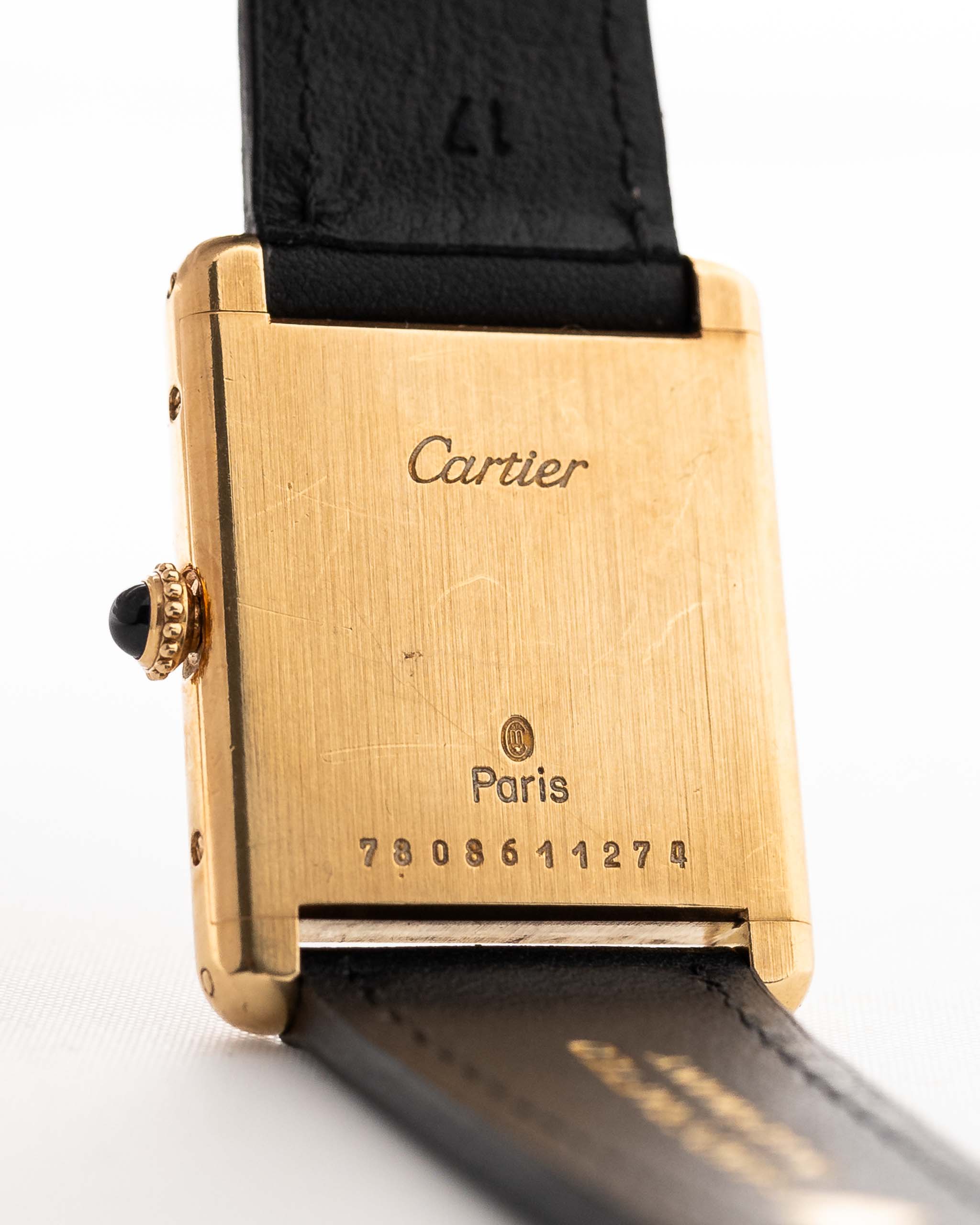 Closeup of a Vintage Cartier Tank Louis 78086 Paris Case from the 1970s. 23x30mm with 18k Yellow Gold Case, Manual Wind Movement, Flawless Ivory Dial, Hands and Leather Strap.