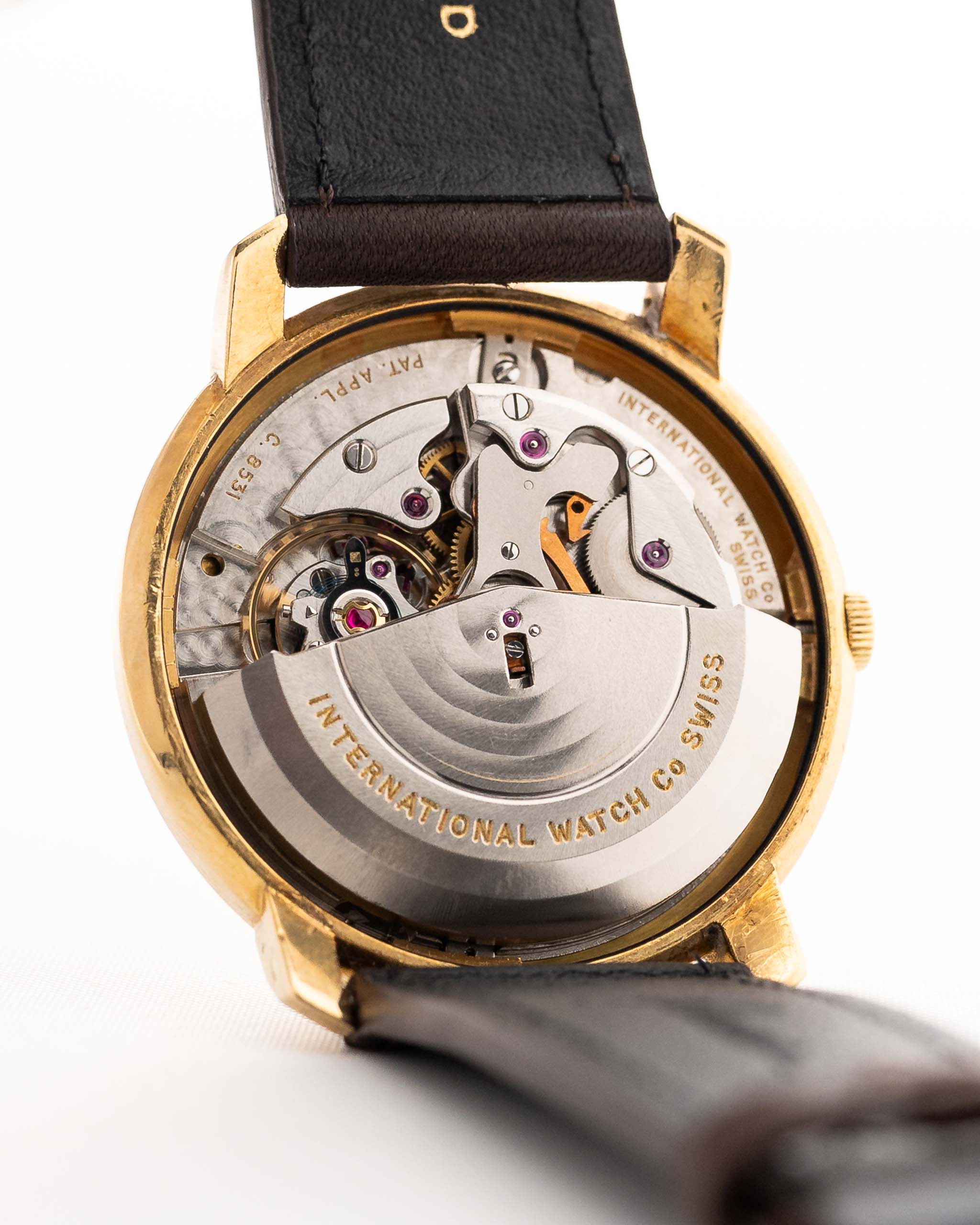 Closeup of a Vintage IWC de Luxe automatic 18k 1959 Movement. 35mm with 18k Yellow Gold Case, Automatic Caliber 8531, flawless Pie Pan Dial and Leather Strap.