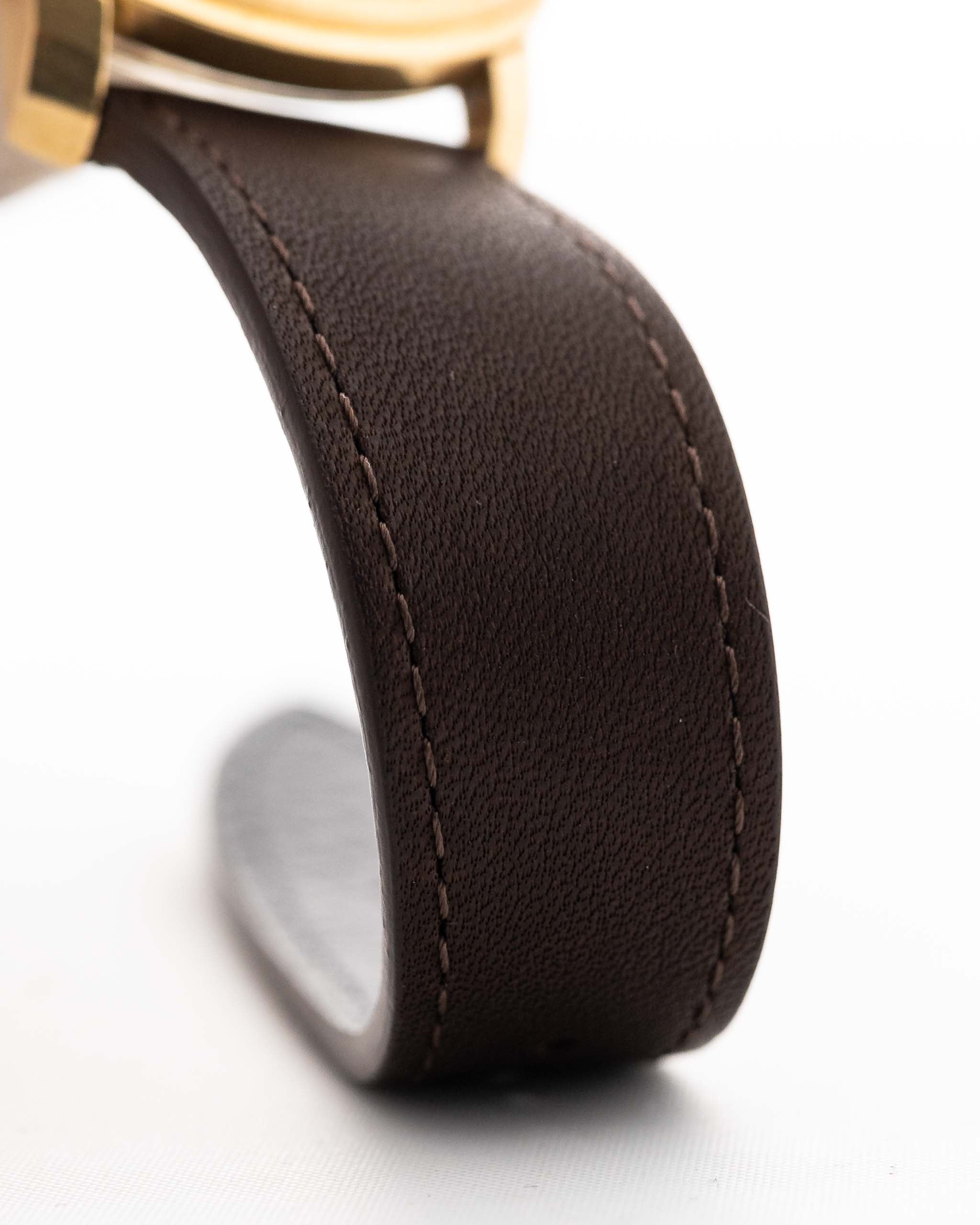 Closeup of a Vintage IWC de Luxe automatic 18k 1959 Leather Strap. 35mm with 18k Yellow Gold Case, Automatic Caliber 8531, flawless Pie Pan Dial and Leather Strap.