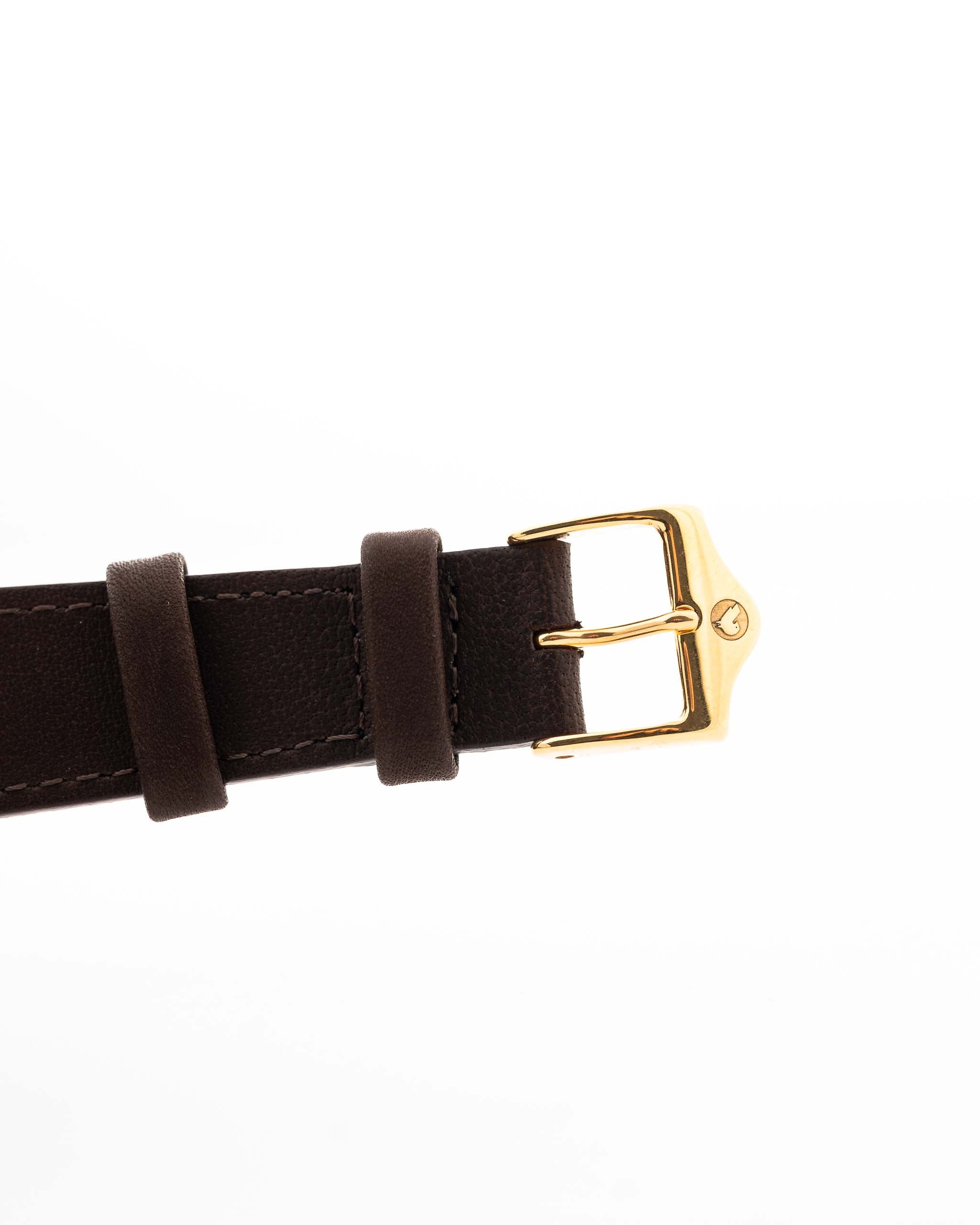 Closeup of a Vintage IWC de Luxe automatic 18k 1959 Leather Strap with buckle. 35mm with 18k Yellow Gold Case, Automatic Caliber 8531, flawless Pie Pan Dial and Leather Strap.