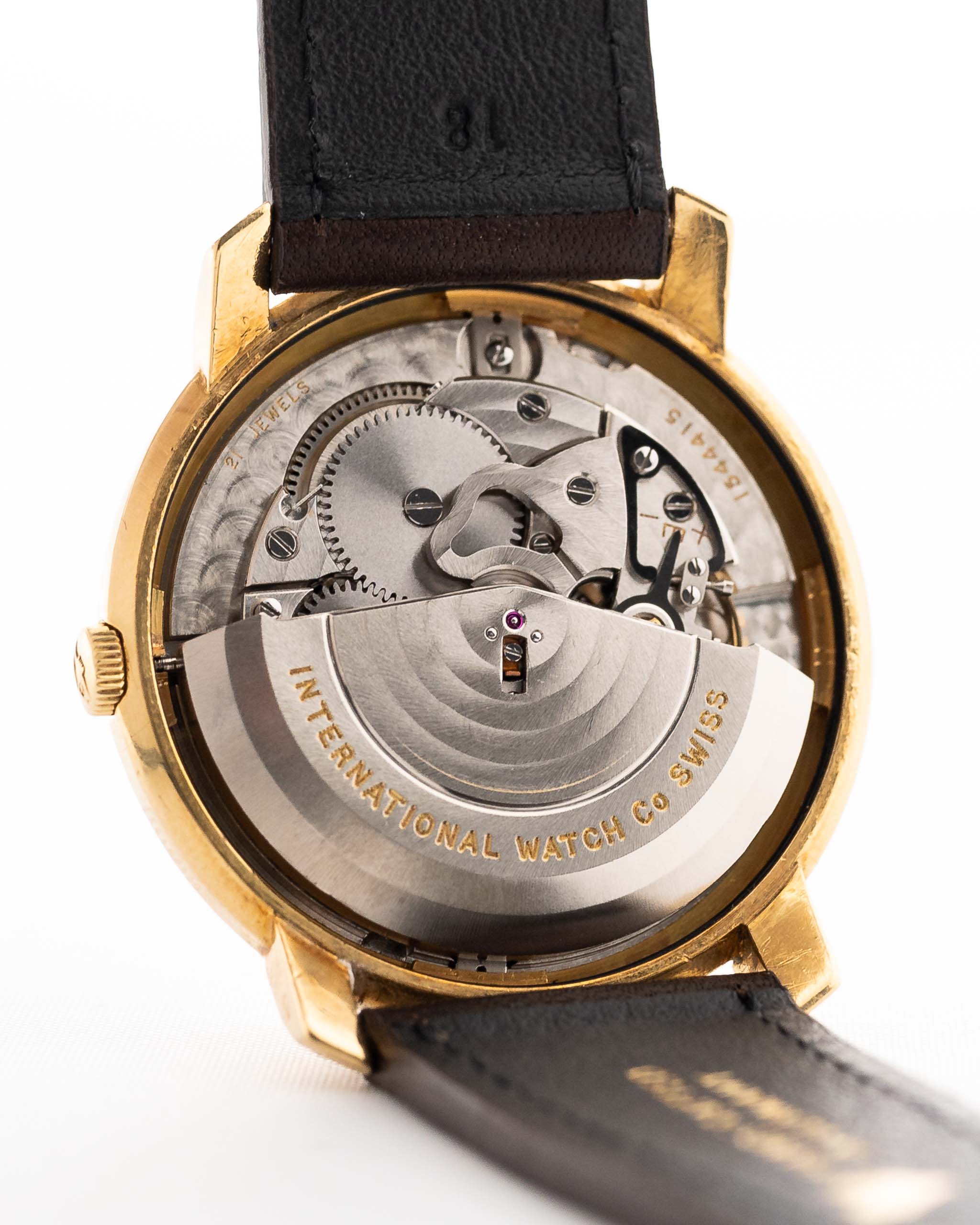 Closeup of a Vintage IWC de Luxe automatic 18k 1959 Movement. 35mm with 18k Yellow Gold Case, Automatic Caliber 8531, flawless Pie Pan Dial and Leather Strap.