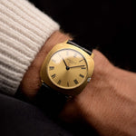 Patek Philippe 3543 Square Roman from the 1970s on a wrist. 31mm in 18k Yellow Gold with Manual wind movement, Golden sunburst dial and Original Leather strap.