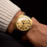 Patek Philippe 3543 Square Roman from the 1970s on a wrist. 31mm in 18k Yellow Gold with Manual wind movement, Golden sunburst dial and Original Leather strap.