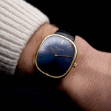 Photo of a Patek Philippe Ellipse 3838J from the 1980s on a wrist. 31mm case in Yellow Gold with Quartz Cal. E27, Flawless Blue Sigma Dial, Original Leather Strap and Gold Buckle.