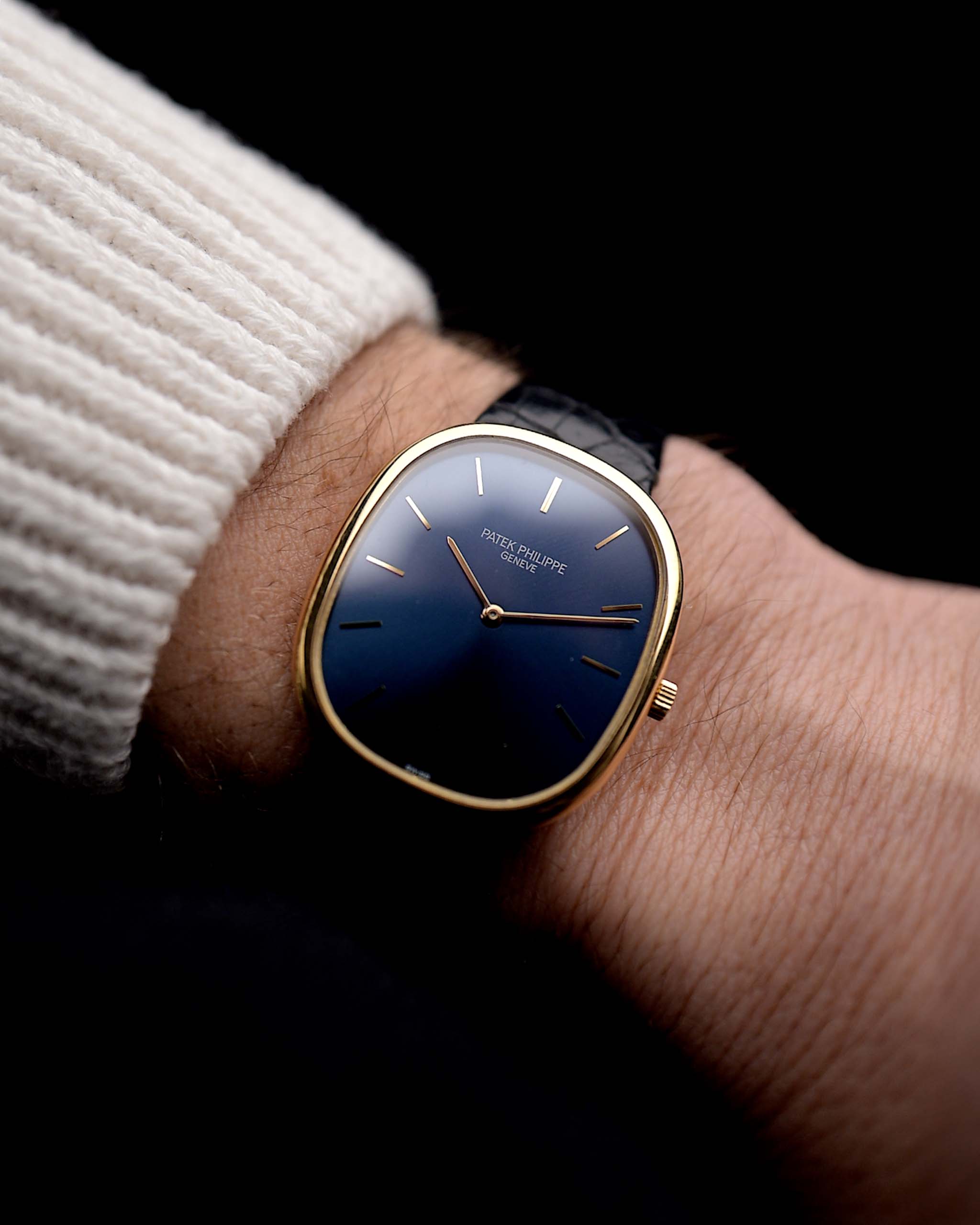 Photo of a Patek Philippe Ellipse 3838J from the 1980s on a wrist. 31mm case in Yellow Gold with Quartz Cal. E27, Flawless Blue Sigma Dial, Original Leather Strap and Gold Buckle.