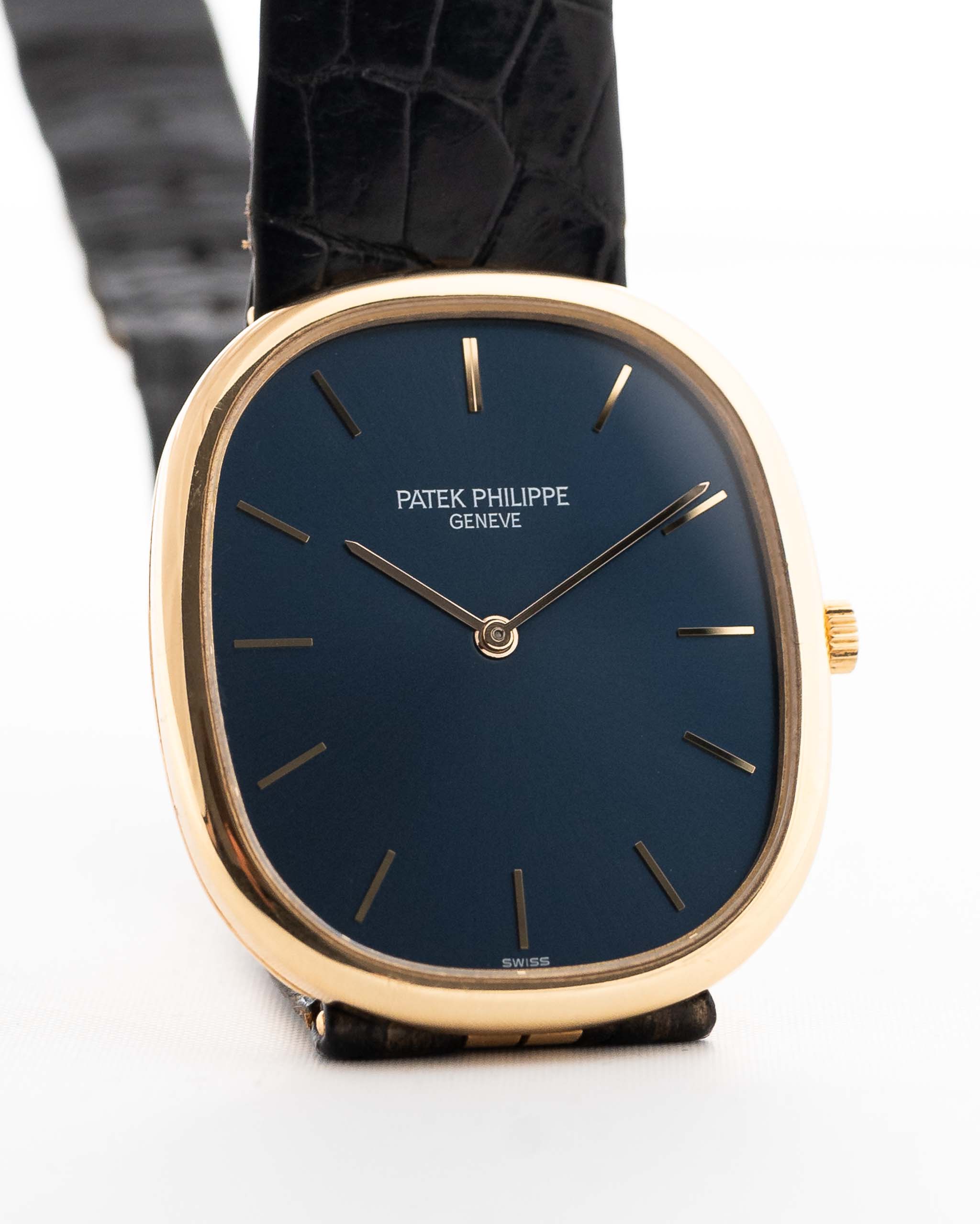 Closeup Photo of a Patek Philippe Ellipse 3838J from the 1980s. 31mm case in Yellow Gold with Quartz Cal. E27, Flawless Blue Sigma Dial, Original Leather Strap and Gold Buckle.