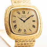 Vintage Piaget Square Watch 75121 Roman Bark from the 1970s. 34mm in 18k Yellow Gold with Quartz movement, Flawless Gold dial and Integrated bracelet.