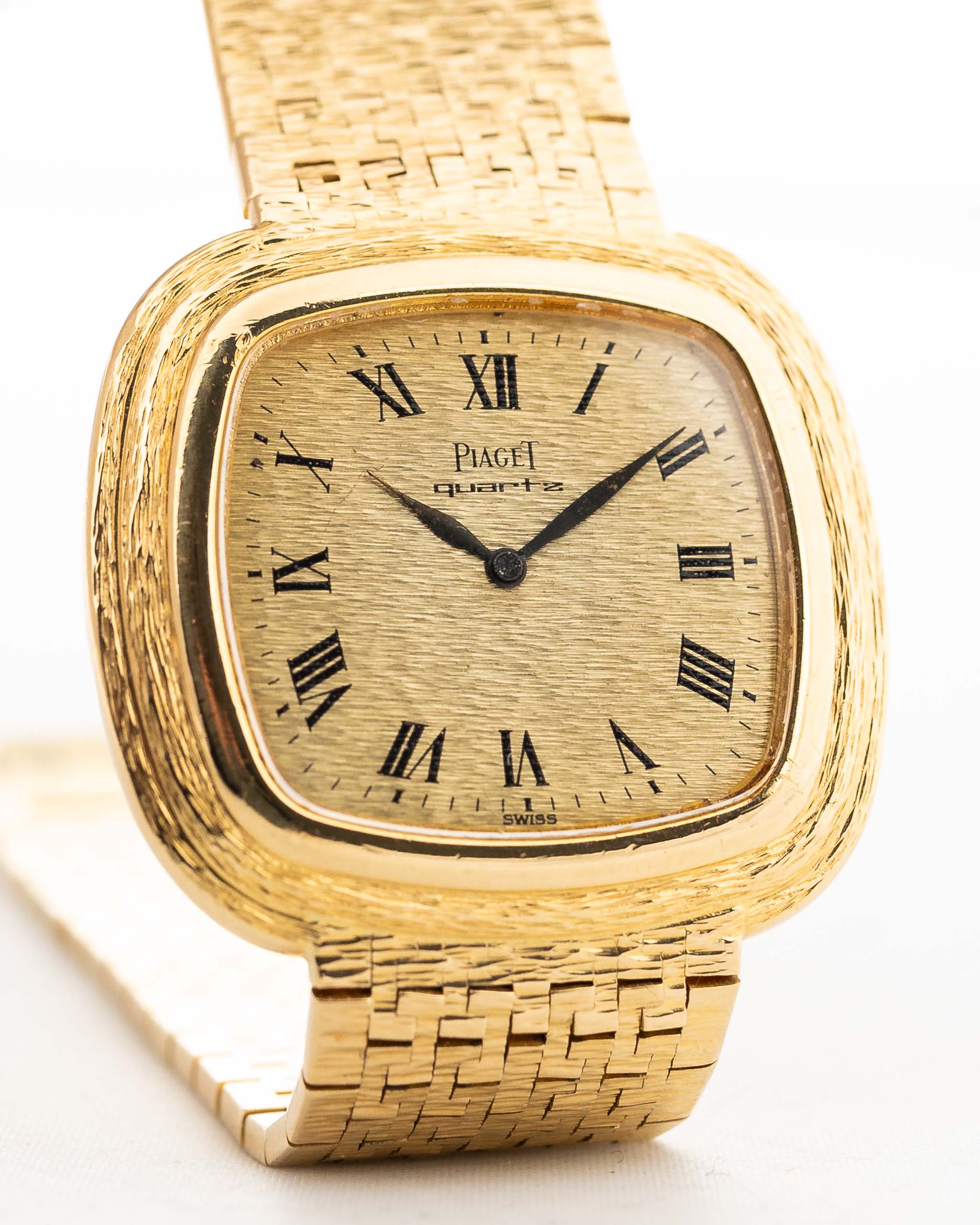 Vintage Piaget Square Watch 75121 Roman Bark from the 1970s. 34mm in 18k Yellow Gold with Quartz movement, Flawless Gold dial and Integrated bracelet.