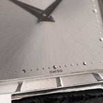 Closeup Photo of a Piaget Protocole 927 18k White Gold from the 1970s. 25mm in 18k White Gold with Manual wind movement, Silver sunburst dial and Original black leather strap.