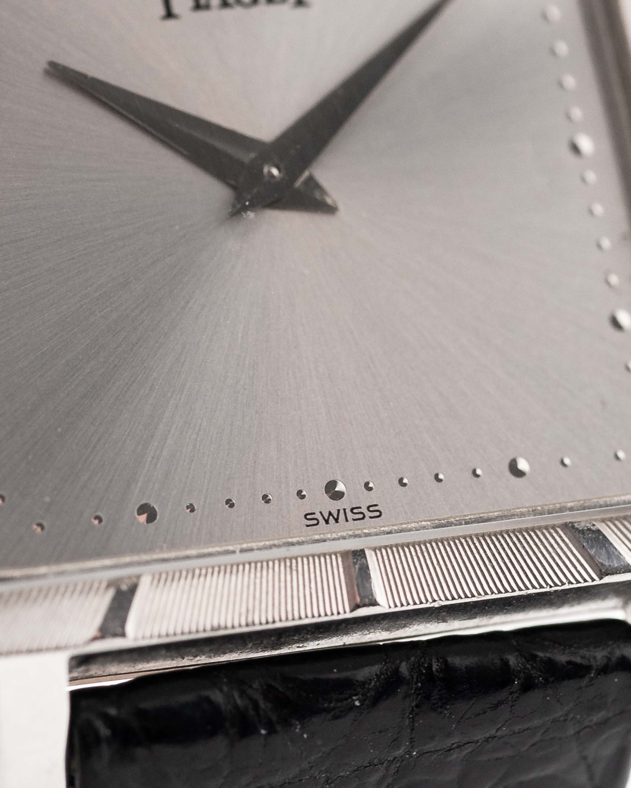 Closeup Photo of a Piaget Protocole 927 18k White Gold from the 1970s. 25mm in 18k White Gold with Manual wind movement, Silver sunburst dial and Original black leather strap.