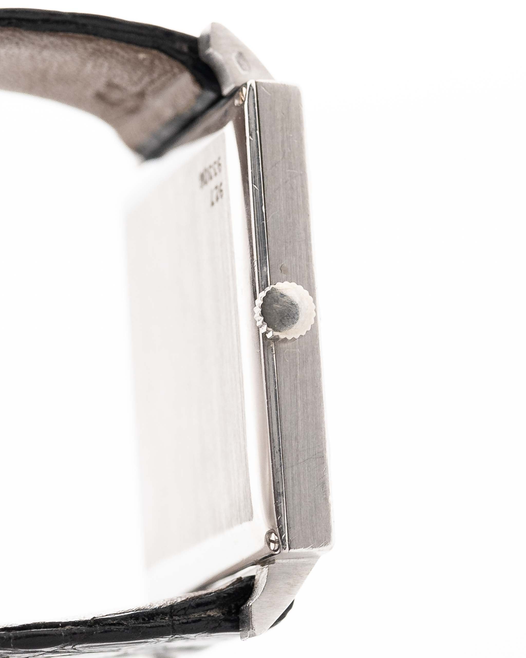 Closeup Photo of a Piaget Protocole 927 18k White Gold from the 1970s. 25mm in 18k White Gold with Manual wind movement, Silver sunburst dial and Original black leather strap.