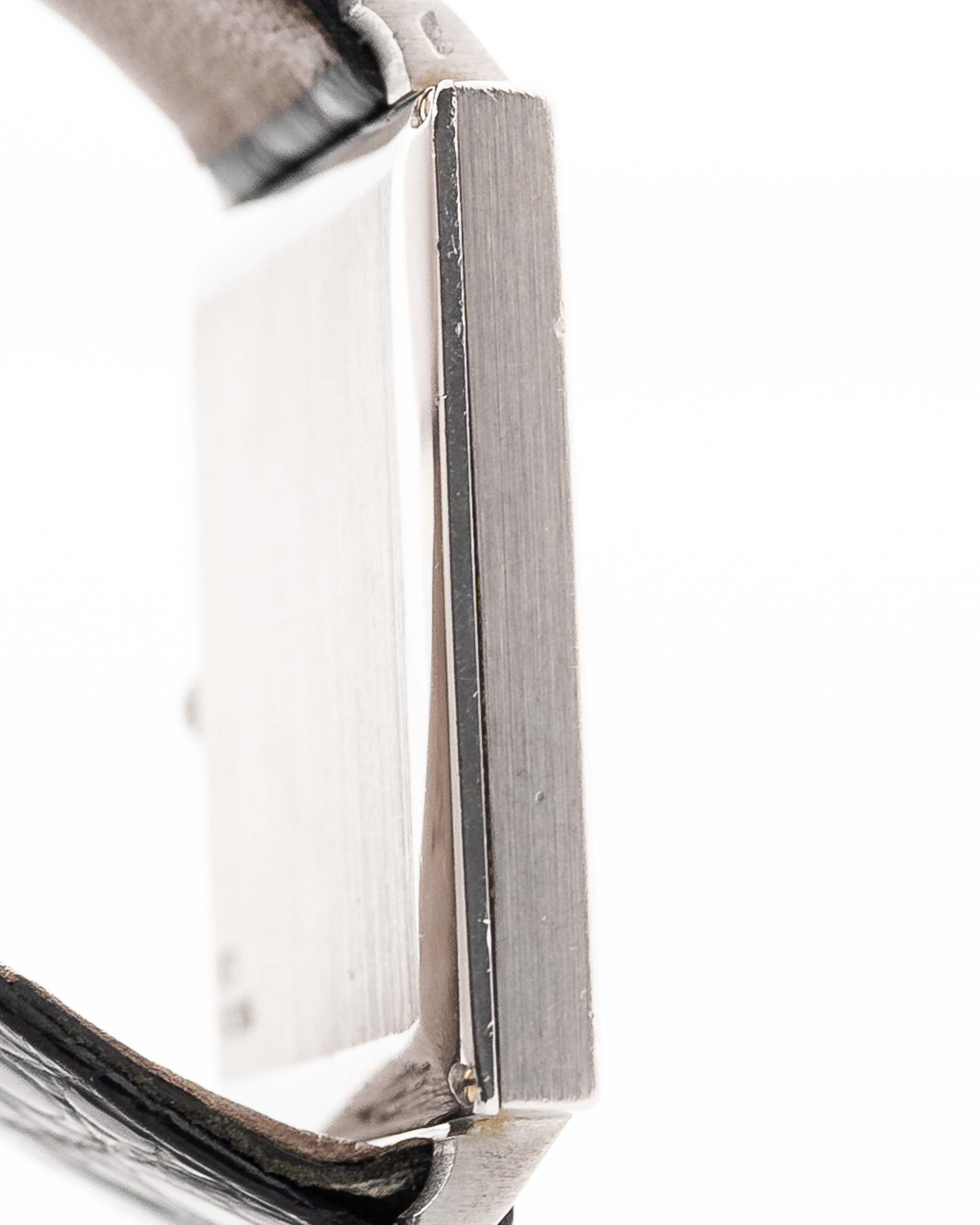 Closeup Photo of a Piaget Protocole 927 18k White Gold from the 1970s. 25mm in 18k White Gold with Manual wind movement, Silver sunburst dial and Original black leather strap.