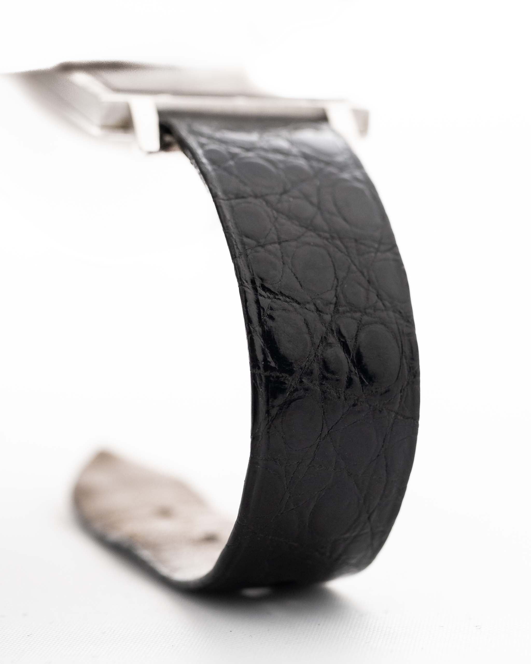 Closeup Photo of a Piaget Protocole 927 18k White Gold from the 1970s. 25mm in 18k White Gold with Manual wind movement, Silver sunburst dial and Original black leather strap.