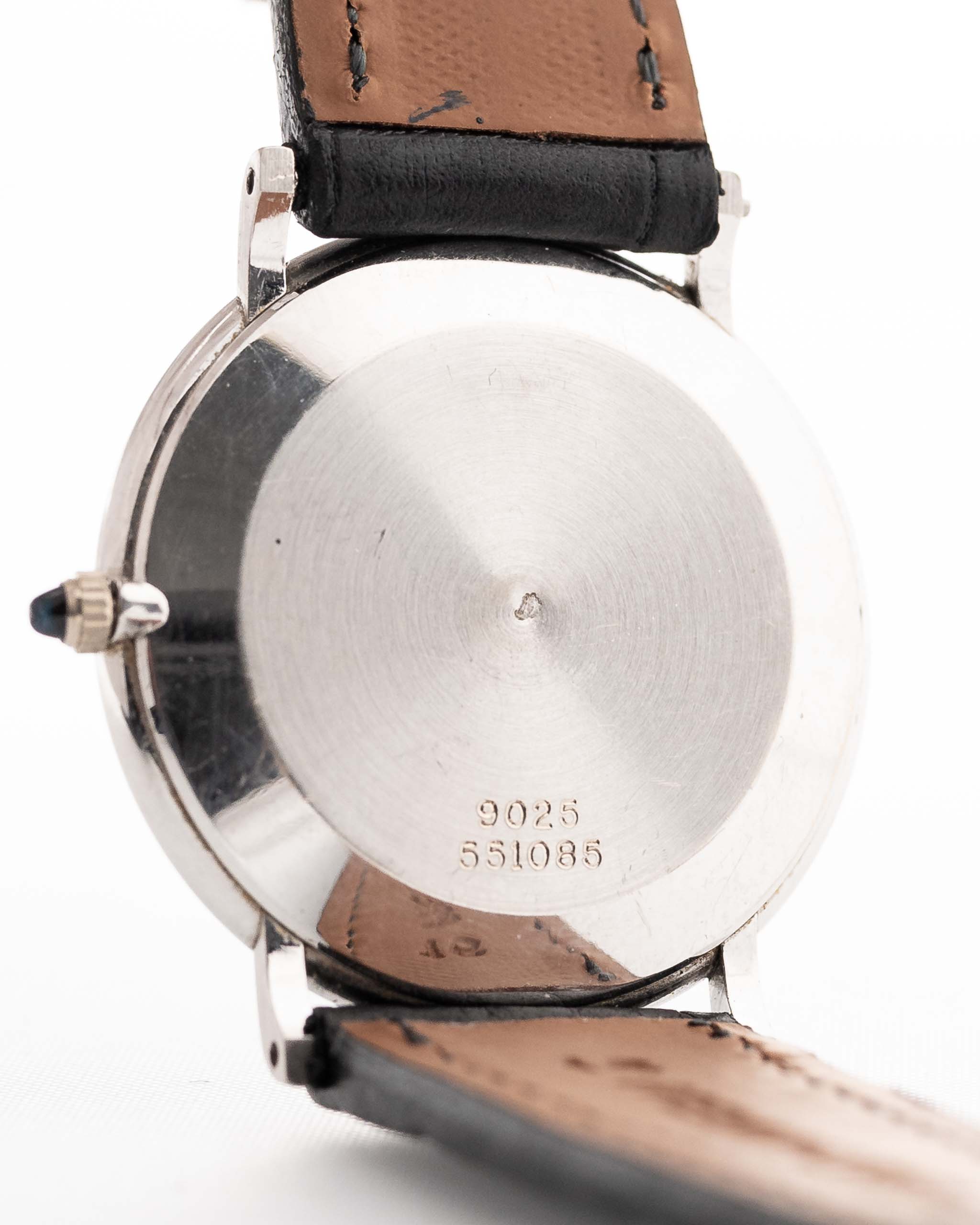 Closeup of a Vintage Piaget Altiplano 9025 Case with Diamond 18k Grey from 1990s. 33mm in 18k white gold with Manual wind movement, Dark grey sunburst dial, Diamond hour markers and black Leather strap.