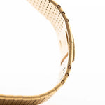 Closeup of Vintage Piaget Polo 7131 C5 bracelet. 23mm in 18k Yellow Gold with Guilloche Dial, Integrated 18k Gold Bracelet and Quartz Movement.