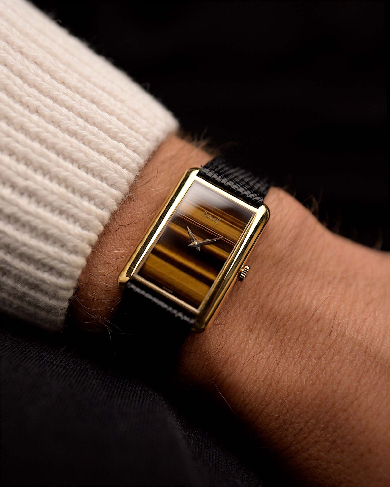 Vintage Piaget Tank Watch 9228 Tiger Eye from the 1970s on a wrist. 34mm in 18k Yellow Gold with Manual wind Caliber 9P, Original Tiger Eye dial and Leather strap.