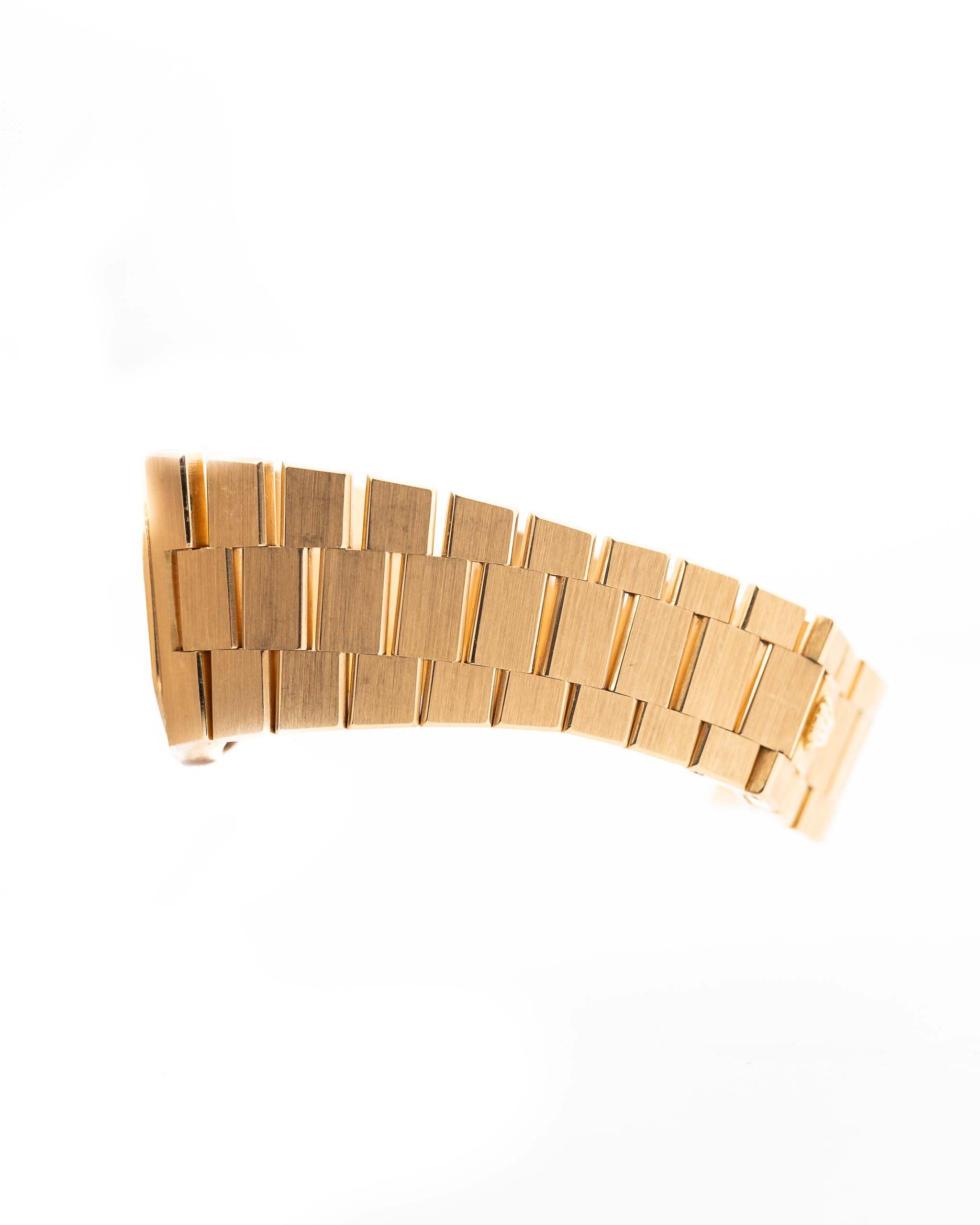 Closeup Photo of a Rolex Cellini 4350 Octagon 18k Silver Dial from 1981 on a wrist. 27mm in 18k Yellow Gold with Manual Wind Movement, Flawless Horizontal Brushed Dial and President Bracelet.