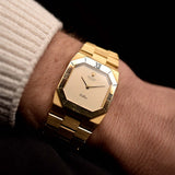 Photo of a  Rolex Cellini 4350 Octagon 18k Silver Dial from 1981 on a wrist. 27mm in 18k Yellow Gold with Manual Wind Movement, Flawless Horizontal Brushed Dial and President Bracelet.