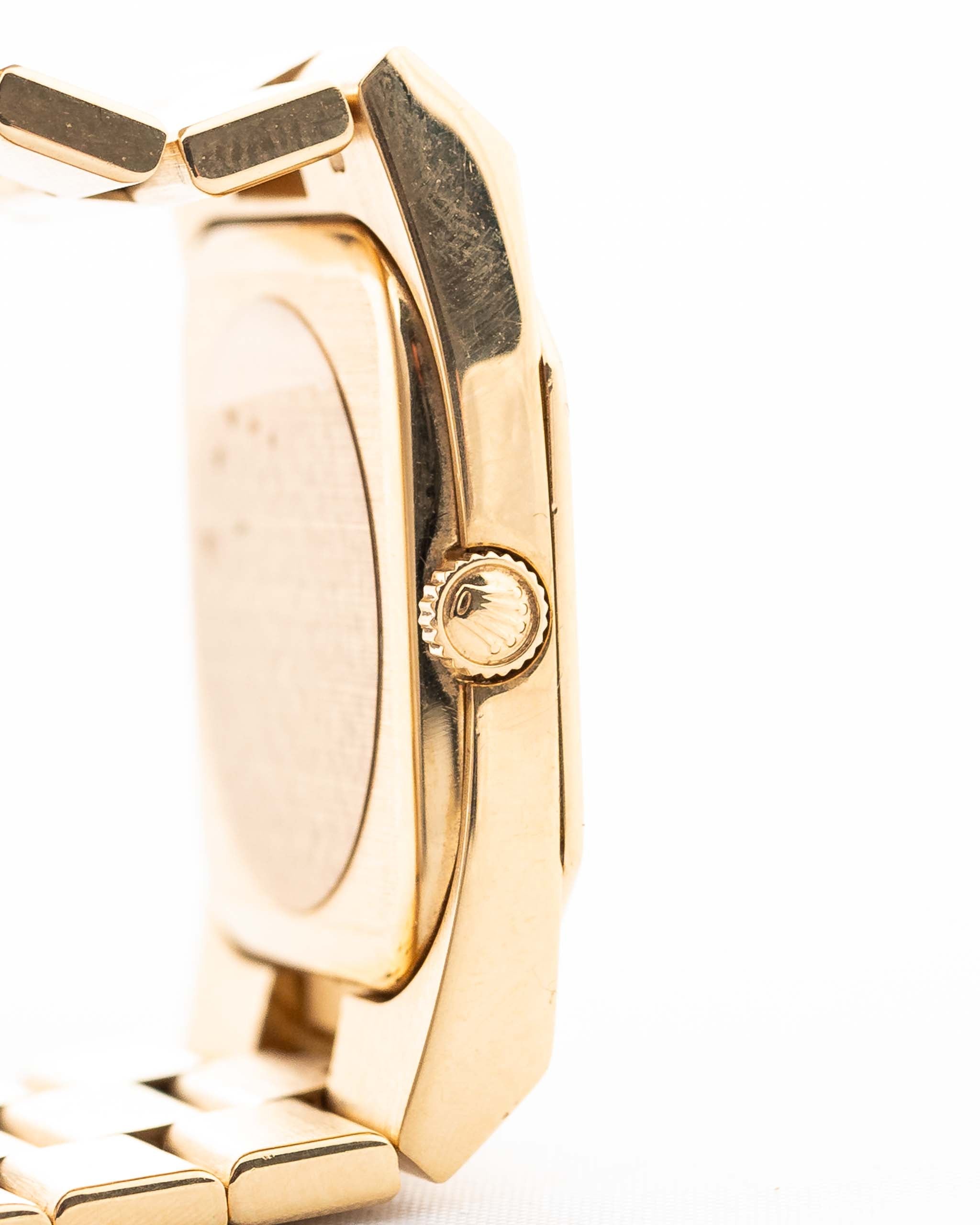 Closeup Photo of a Rolex Cellini 4350 Octagon 18k Silver Dial from 1981 on a wrist. 27mm in 18k Yellow Gold with Manual Wind Movement, Flawless Horizontal Brushed Dial and President Bracelet.