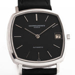 Vacheron Constantin watch with black face and leather strap on a white background
