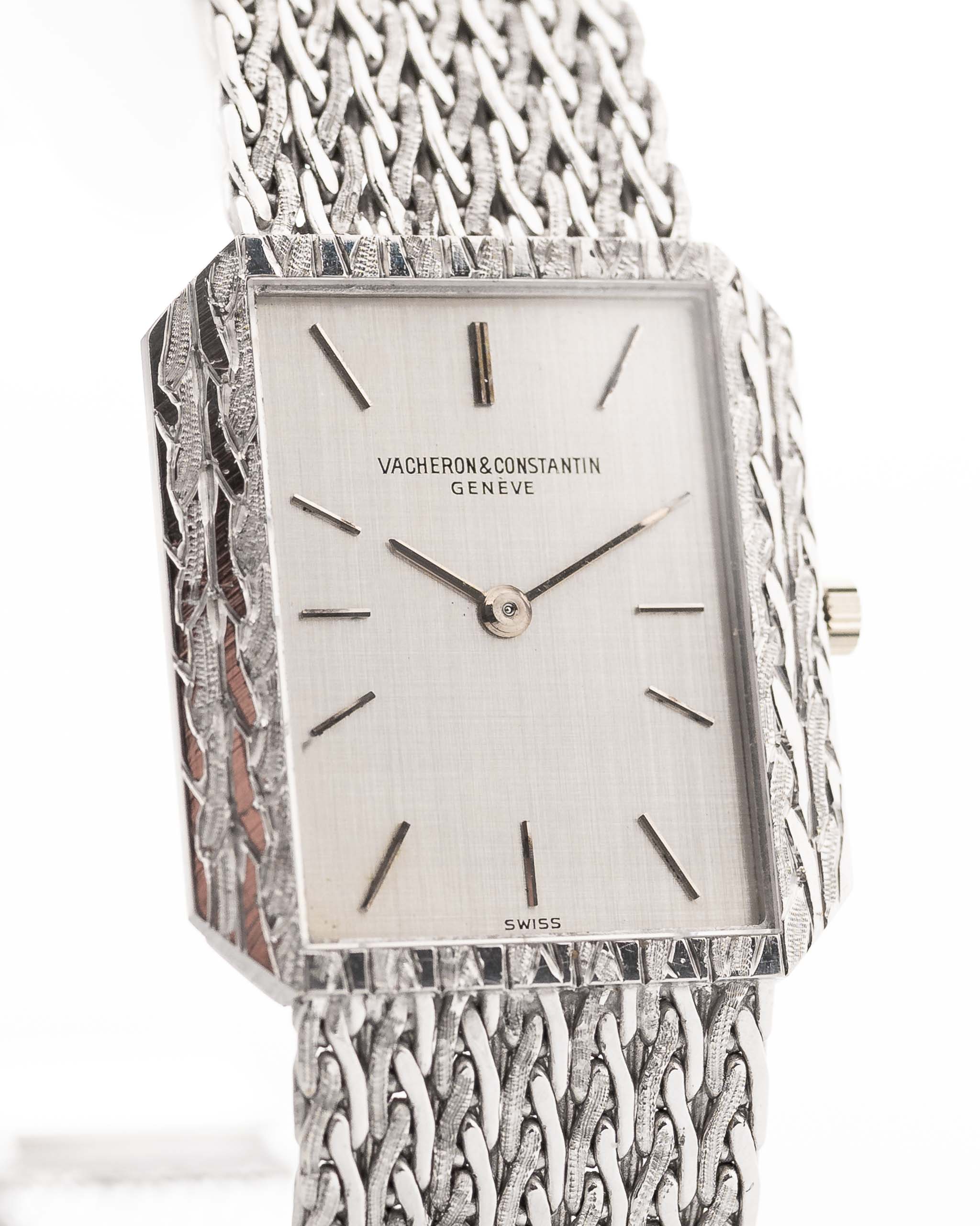 Vintage Vacheron Constantin 7457 Rectangular watch from the 1970s on white background. 25mm wide, 18k White Gold, Manual wind Caliber 1003, Flawless silver linen dial and Braided bracelet.