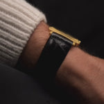 Vintage Patek Philippe 3543 Square Roman from the 1970s on a wrist. 31mm in 18k Yellow Gold with Manual wind movement, Golden sunburst dial and Original Leather strap.