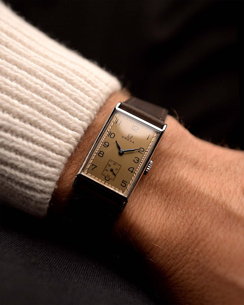 Vintage Omega Rectangular Art Deco watch Salmon from 1935. 20x37mm in Stainless Steel with Manual wind movement, Flawless salmon dial, Dark brown Leather strap.