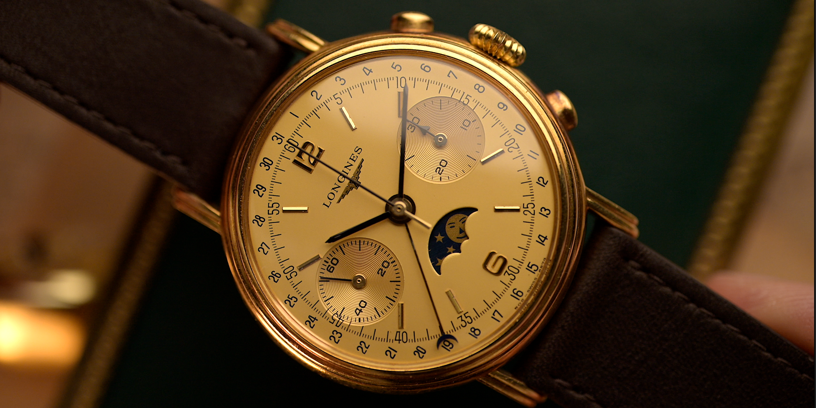 Vintage Longines gold chronograph with moon phase complication and brown leather strap