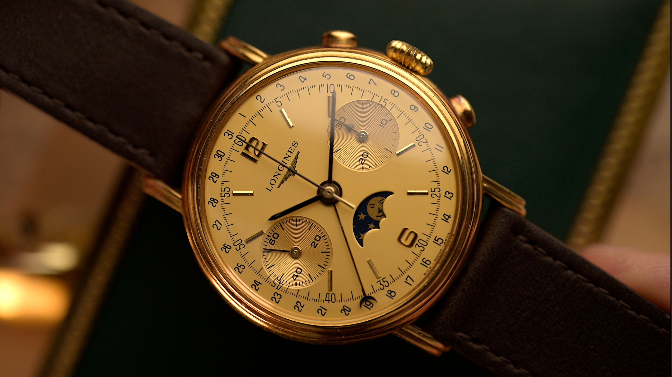 Vintage Longines gold chronograph with moon phase complication and brown leather strap