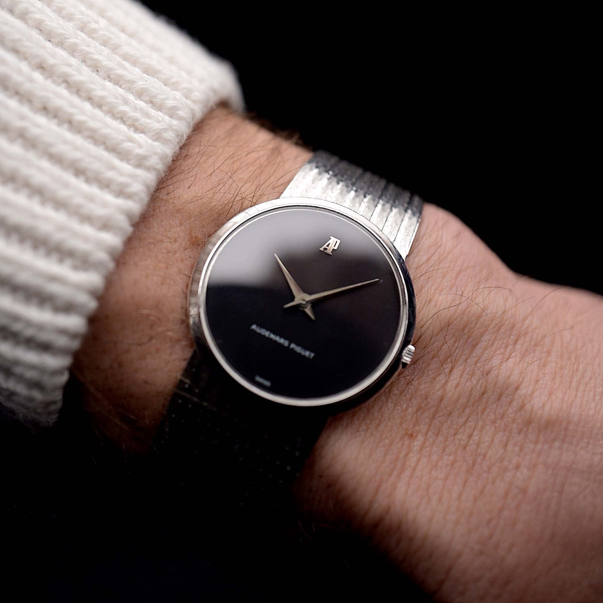 Photo of a Audemars Piguet 18k Black from the 1970s on a wrist. 31.5mm 18k White Gold Case with Manual wind Cal. 2003, Deep black dial and 18k White Gold Bracelet.
