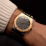 Vintage Audemars Piguet 4100SA Royal Oak Watch from the 1980s on a wrist. 36mm in Stainless Steel & 18k Yellow Gold with Rare flawless grey tapisserie dial, Two-Tone bracelet and Automatic movement.