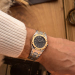 Vintage Audemars Piguet 4100SA Royal Oak Watch from the 1980s on a wrist. 36mm in Stainless Steel & 18k Yellow Gold with Rare flawless grey tapisserie dial, Two-Tone bracelet and Automatic movement.