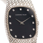 A closeup photo of a vintage Audemars Piguet Cobra watch from 1980s on a wrist. White gold, 27mm, Manual wind Cal. 2080, Original flawless dial with 12 diamonds and White gold mesh bracelet.