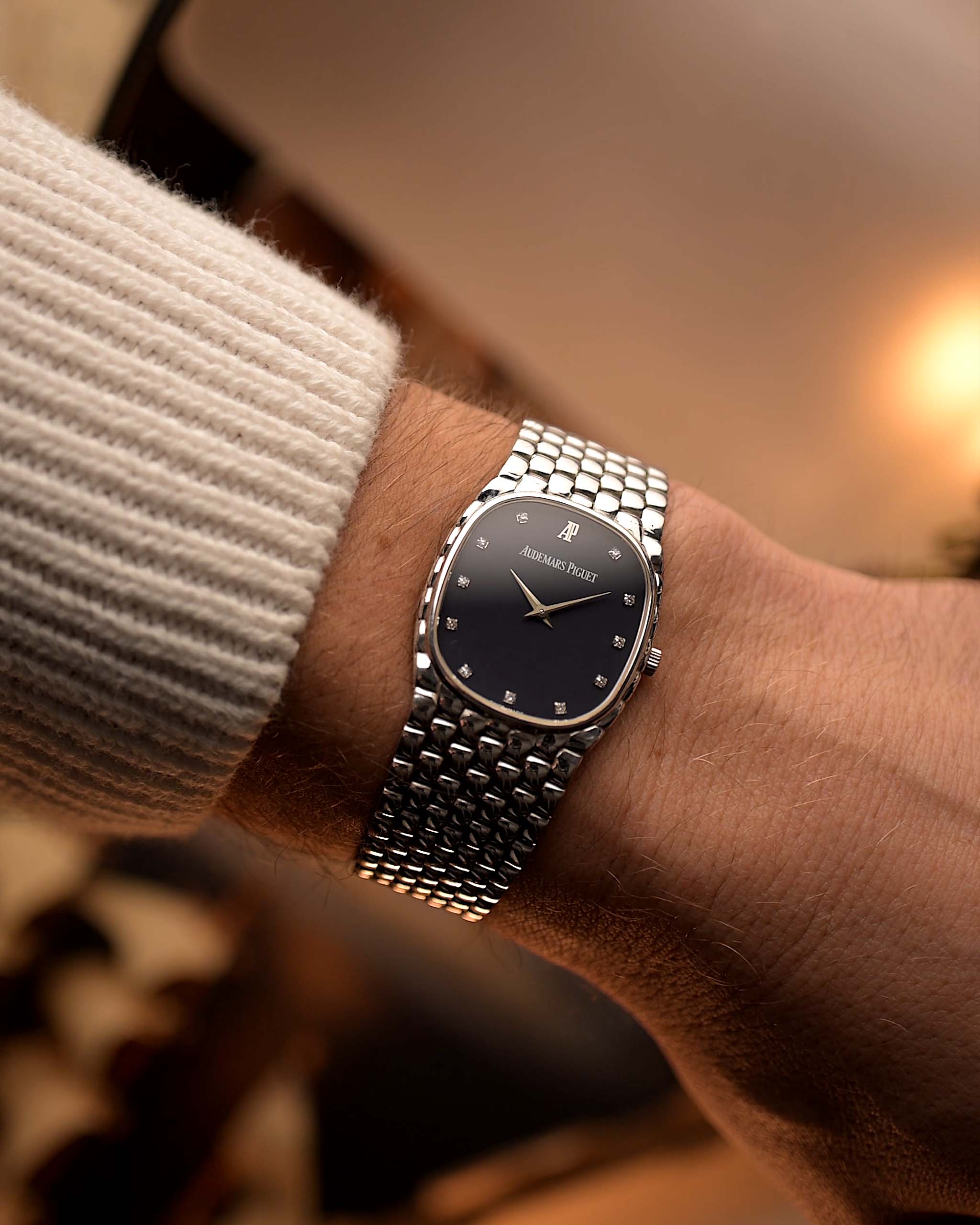 Vintage Audemars Piguet Cobra watch, 18k white gold, night blue diamond dial, manual movement, integrated bracelet, on wrist, blurred background