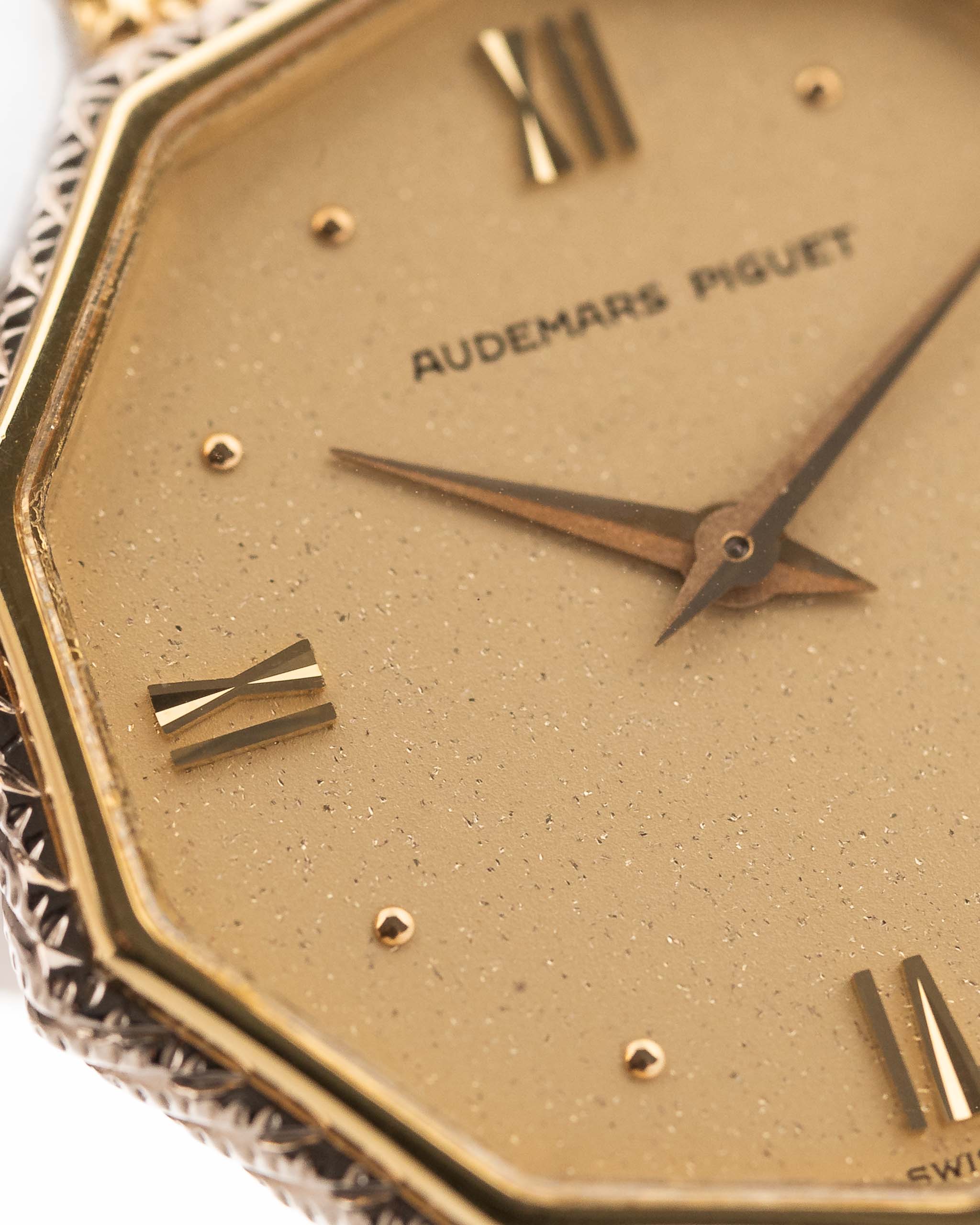 Closeup Photo of a Audemars Piguet Octagon Two Tone 18k from the 1980s. 30mm with 18k Yellow Gold Case, Golden Aventurine Dial, Manual Wind Movement and Yellow Gold Bracelet.