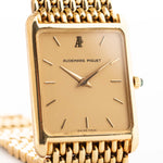 Closeup Photo of a Audemars Piguet 18k Tank from the 1980s. 25mm case in 18k Yellow Gold with Manual wind movement, Original golden dial, Hands with sapphire cabochon and Beads of rice bracelet.