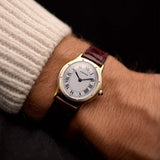 Vintage Cartier Arcade Paris Watch 9605 Two Tone from the 1980s on a wrist. 24mm with 18k Yellow Gold Case, White Gold Bezel, White Paris Dial, Manual Wind Movement and Leather Strap.