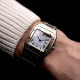 Photo of a Vintage Cartier Santos Carrée 2961 Two Tone from 1990s on wrist. Two-tone stainless steel, Original white dial, Automatic movement and original bracelet.