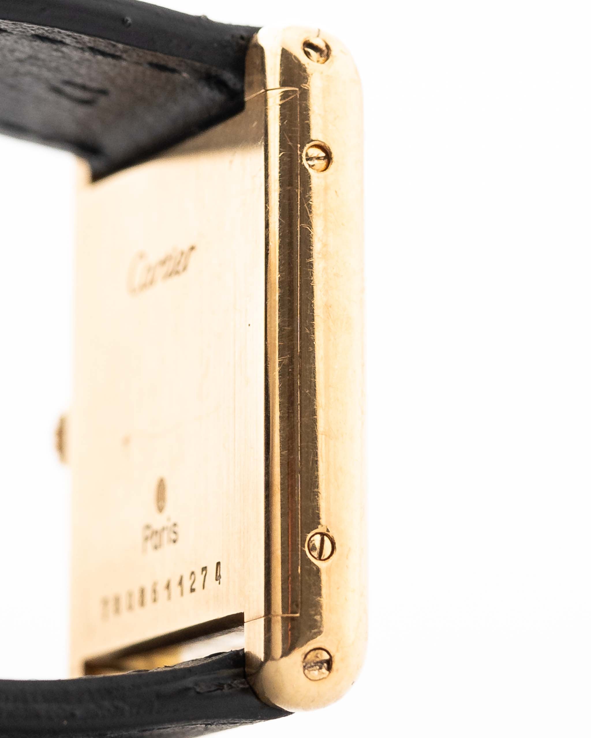 Closeup of a Vintage Cartier Tank Louis 78086 Paris Case from the 1970s. 23x30mm with 18k Yellow Gold Case, Manual Wind Movement, Flawless Ivory Dial, Hands and Leather Strap.