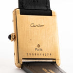 Closeup of a Vintage Cartier Tank Louis 78086 Paris Case from the 1970s. 23x30mm with 18k Yellow Gold Case, Manual Wind Movement, Flawless Ivory Dial, Hands and Leather Strap.