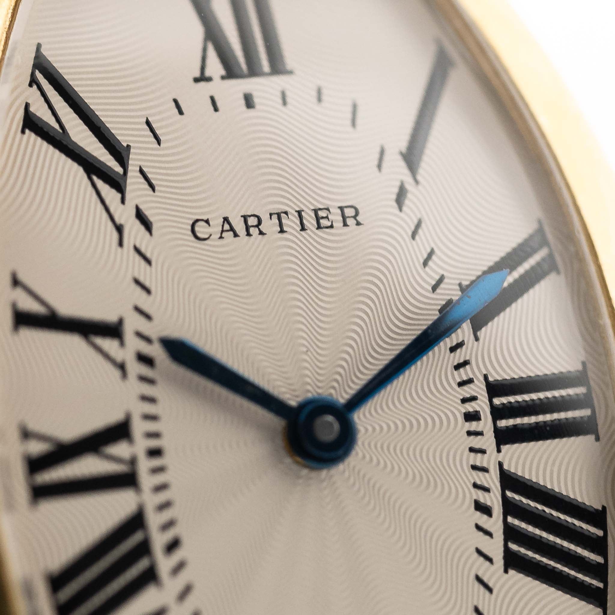 Closeup Photo of a Vintage Cartier Tonneau 18k Guilloché Paris Dial from the 1980s. 39mm with 18k Yellow Gold Case, Manual-winding movement, Original Guilloché Paris dial and black Leather Strap.