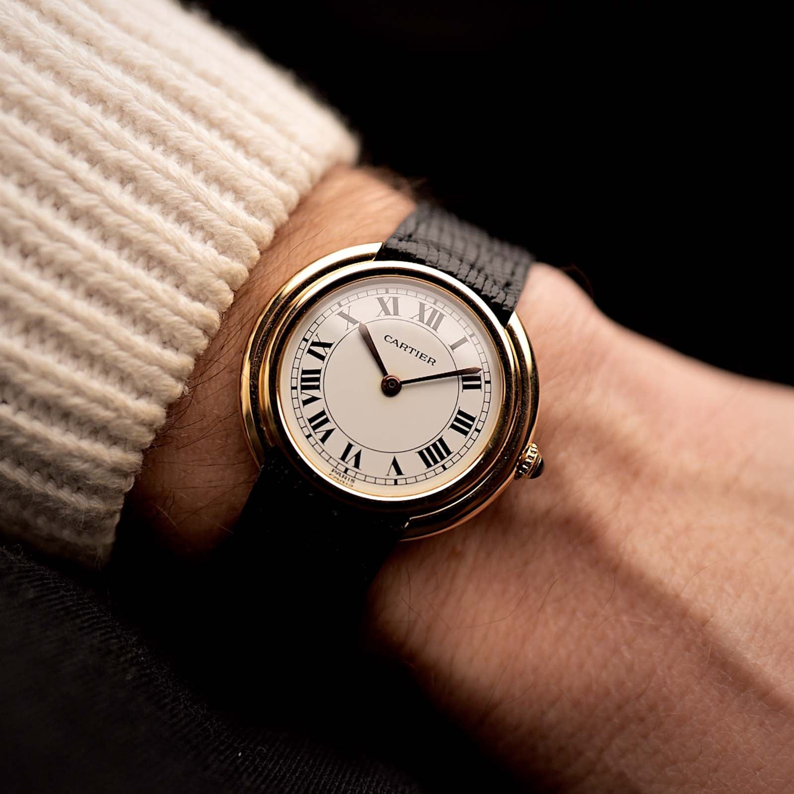 1970年代的卡地亞 Vendôme 復古腕錶，18K 黃金錶殼，白色 MK2 錶盤，自動上鏈機芯，配以黑色背景的腕部特寫