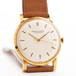 Vintage IWC Cal. 401 Dress Watch R1205 18k from 1964 on a wrist on white background. 