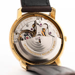 Closeup of a Vintage IWC de Luxe automatic 18k 1959 Movement. 35mm with 18k Yellow Gold Case, Automatic Caliber 8531, flawless Pie Pan Dial and Leather Strap.