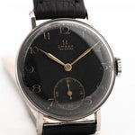 Closeup Photo of a vintage Omega Art Deco Black Syringe Sub Second 1939 on a wrist. In Stainless steel, 30mm with Manual wind movement, Original matte black dial and Leather strap.