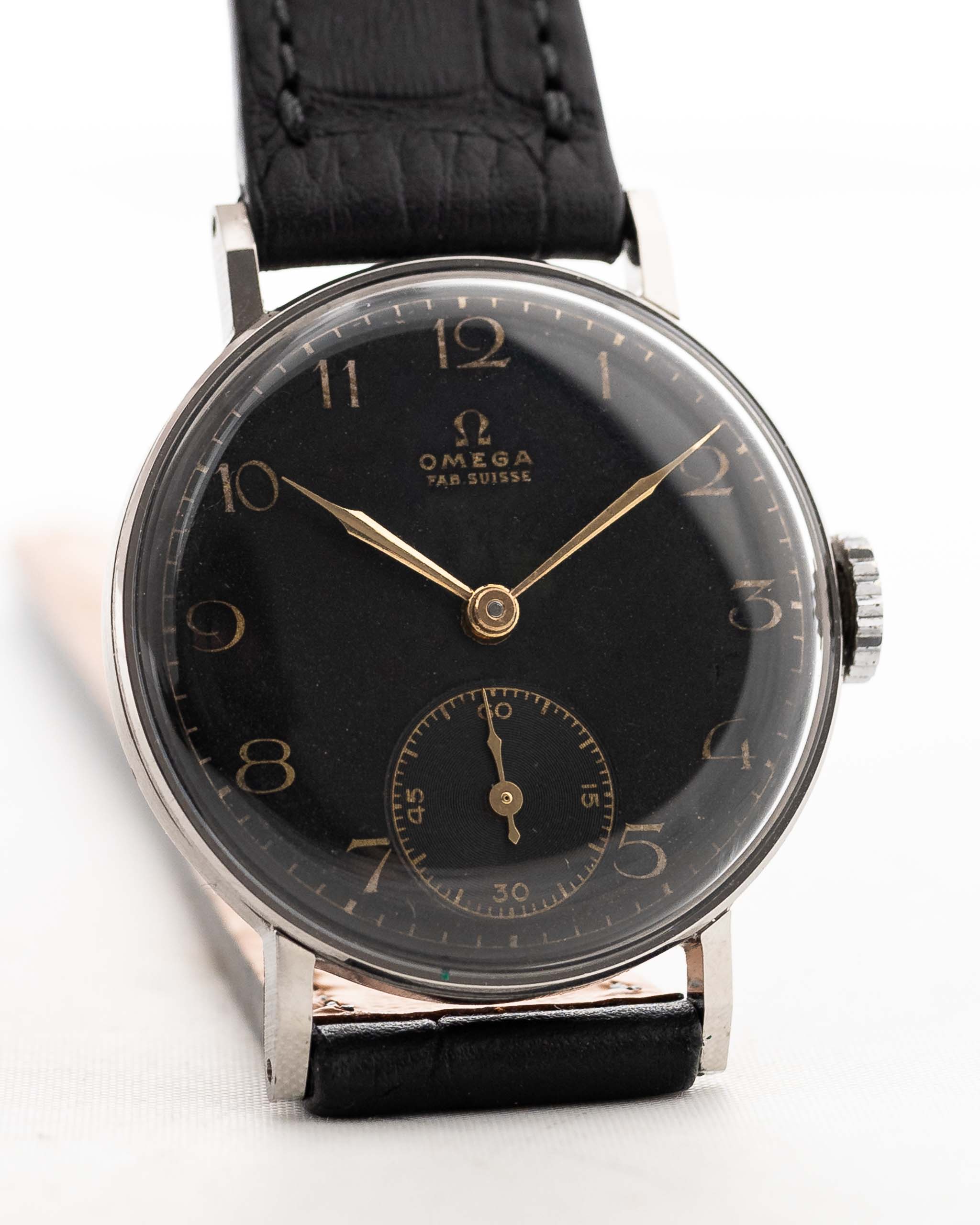 Closeup Photo of a vintage Omega Art Deco Black Syringe Sub Second 1939 on a wrist. In Stainless steel, 30mm with Manual wind movement, Original matte black dial and Leather strap.